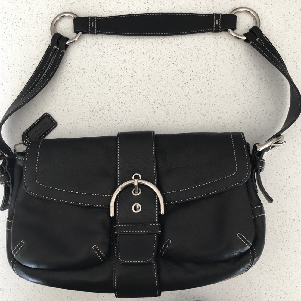 Coach purse.  Black leather with white stitching.